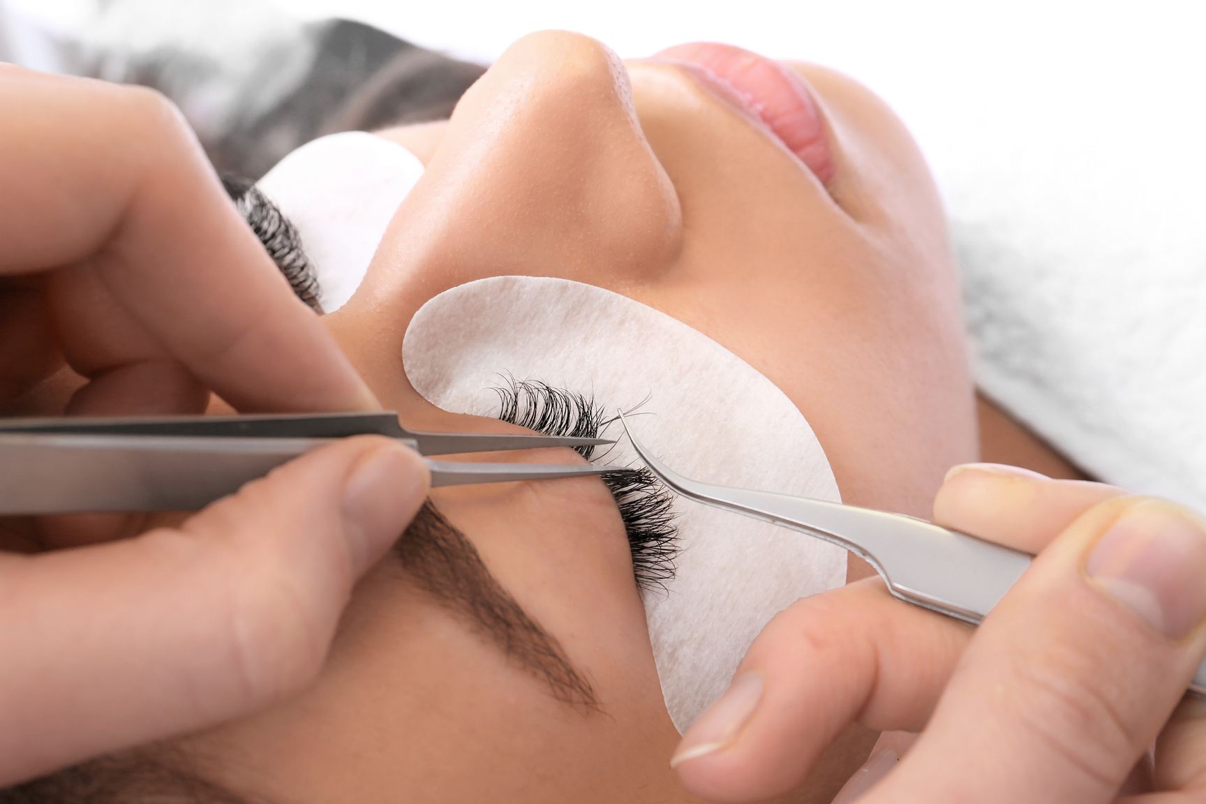 Young Woman Undergoing Eyelash Extensions Procedure