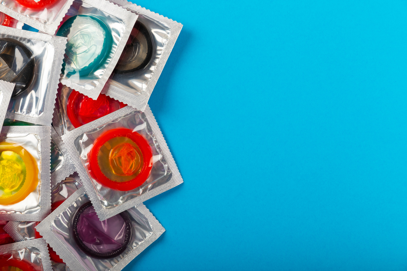 Pile of Condoms on Blue Background